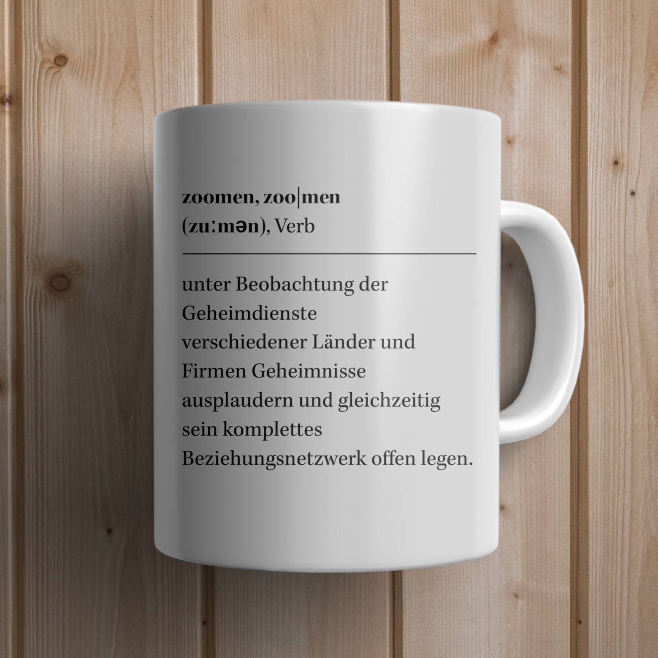 Ein Kaffeebecher mit einem Wörterbucheintrag zu "zoomen".